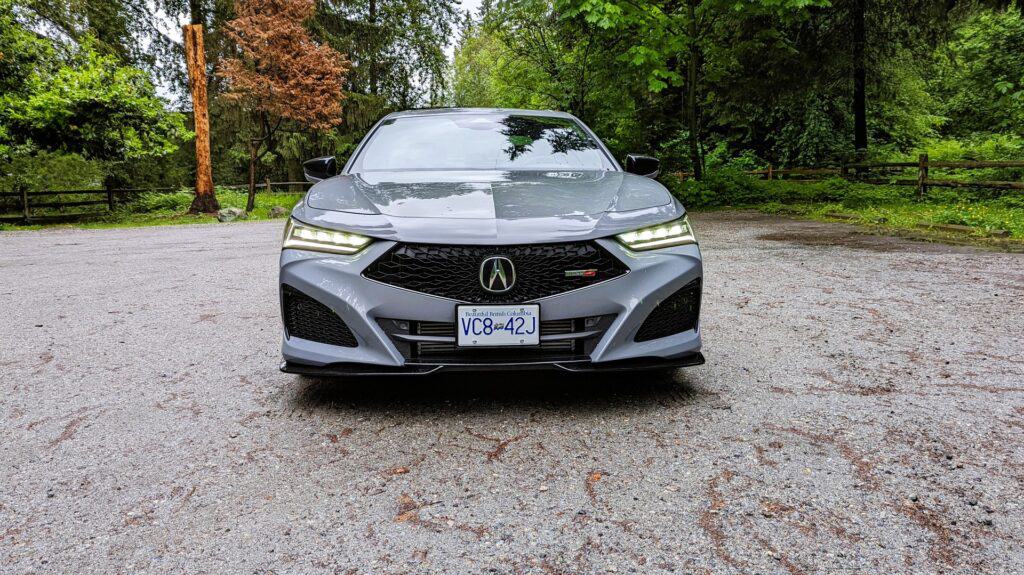 A grey 2024 Acura TLX Type S front shot with head lights on